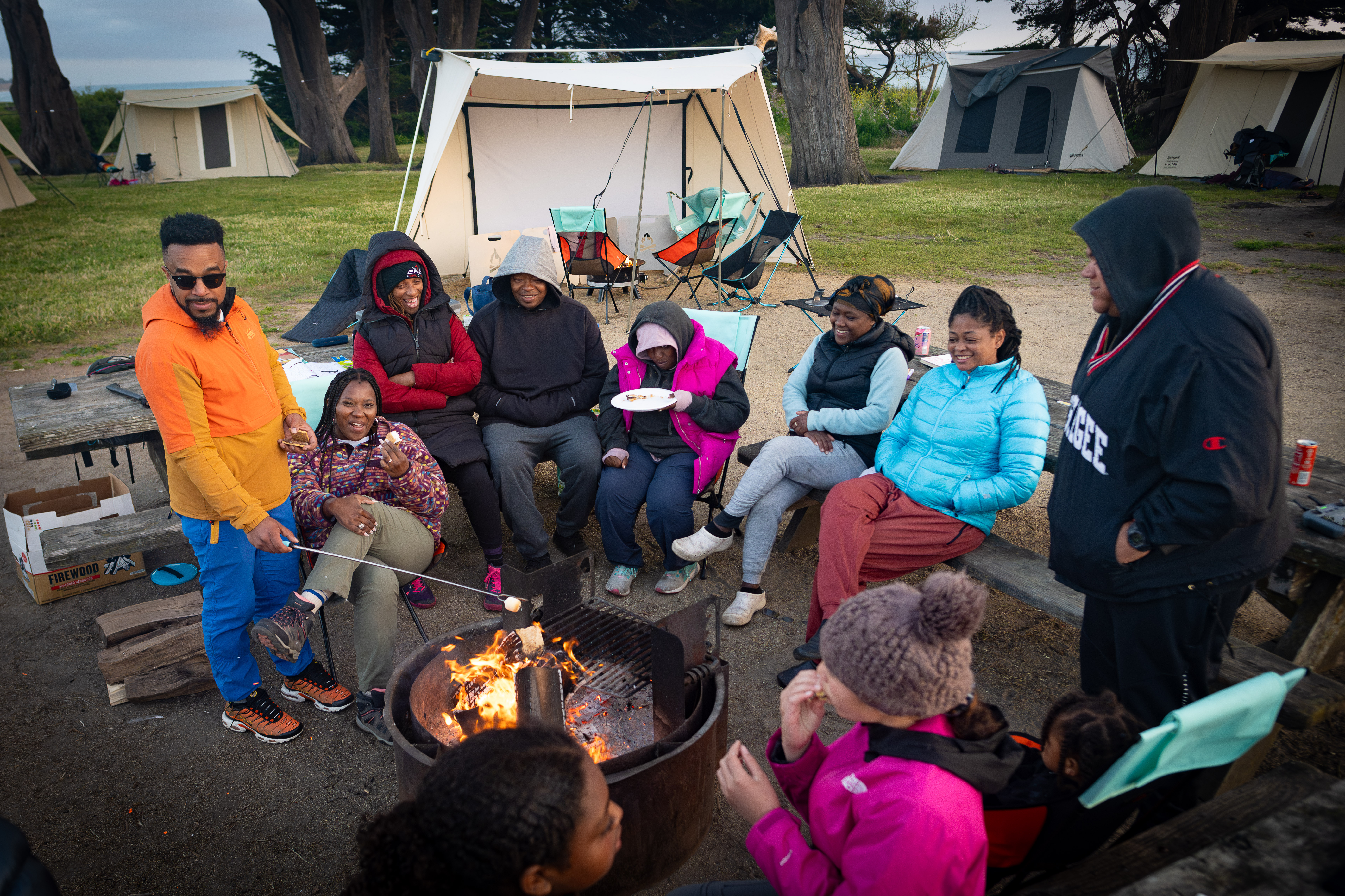 Families gathered around campfire at Half Moon Bay State Beach Sweetwood Group campground